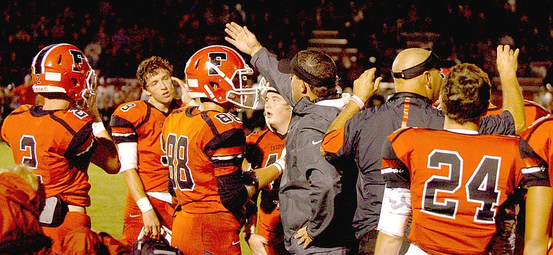 MARK HUMPHREY ENTERPRISE-LEADER Farmington assistant coaches Jay Harper (left) and Tracy Sutton exhort the Cardinal defense during a time-out. Pea Ridge beat the Cardinals, 13-7, at home Friday. Inspired defensive play kept Farmington in the game until the final minute.