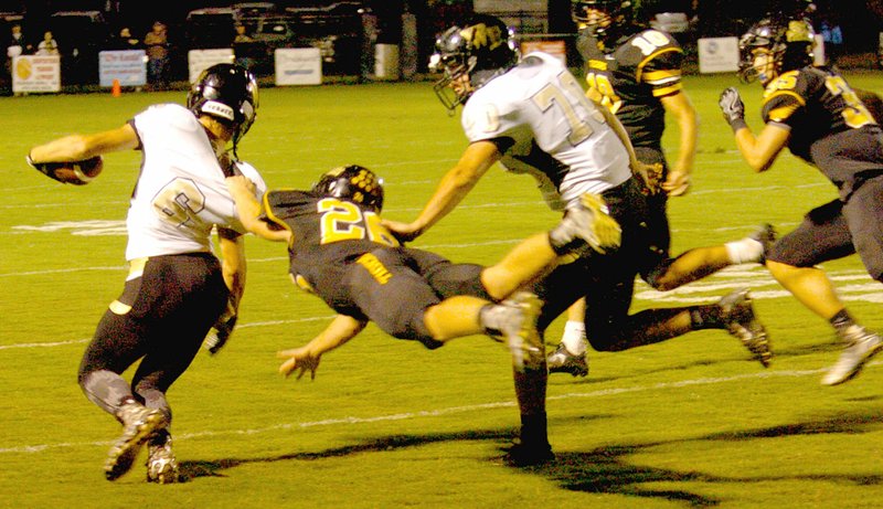 MARK HUMPHREY ENTERPRISE-LEADER Prairie Grove defensive back Clay Fidler makes a leaping tackle of West Fork&#8217;s Devin Worley. Fidle returned an interception for a touchdown as Prairie Grove defeated West Fork 53-0 Friday.