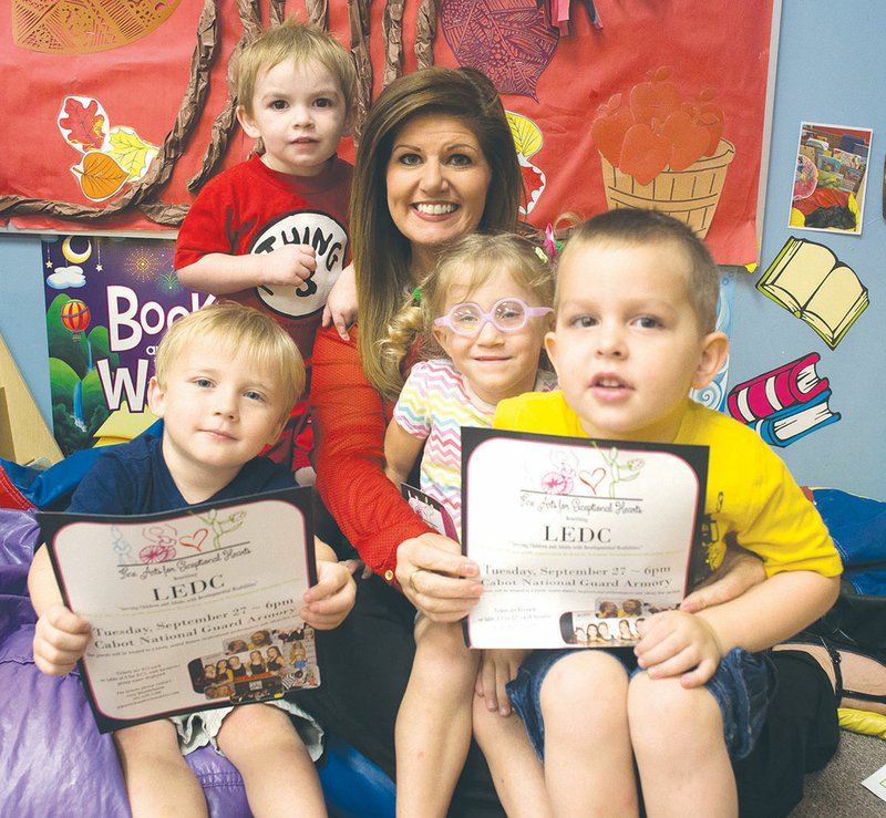 Students from the Lonoke Exceptional Development Center preschool program take a break from their activities to show off flyers for the upcoming fundraiser, Fine Arts for Exceptional Hearts. From left are Jayse Davis, Nolan Adamson, LEDC public relations director Gina Quattlebaum, Lacie Young and Michael Stange.