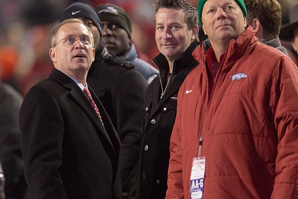 Arkansas athletics director Jeff Long, left, watches the video board during a game against LSU on Saturday, Nov. 15, 2014, in Fayetteville. 
