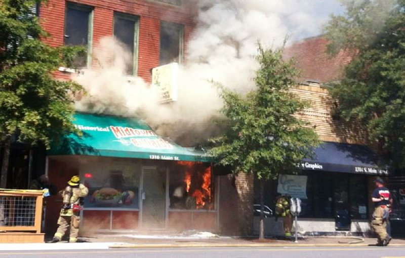 Arkansas Democrat-Gazette/WALTER WEBB

FILE — Smoke and flames poured out of the front of Midtown Billiards in September 2016. 