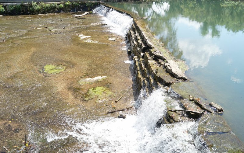 Rita Greene/McDonald County Press Waterfalls running over the old stone mill dam and flowing spring waters of Little Sugar Creek is the view from the dining room and outdoor patio at Haven 55 restaurant at Pineville.