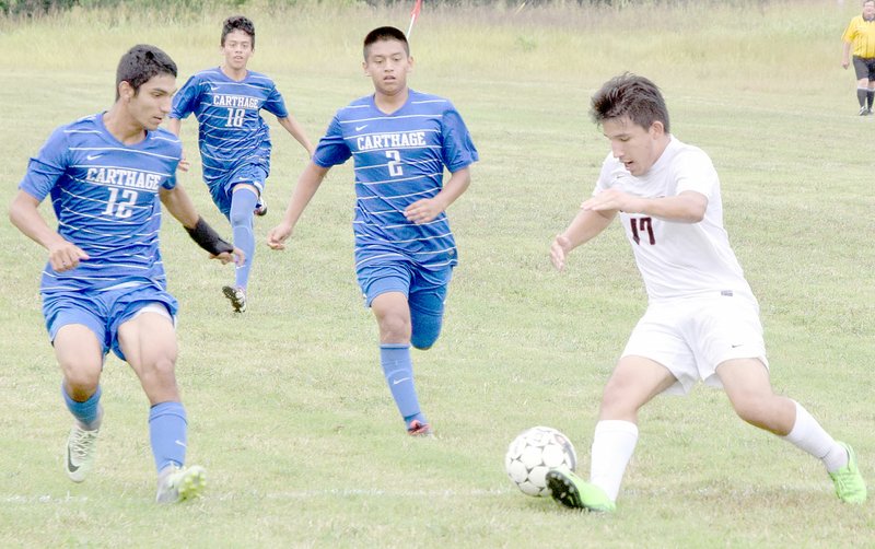 PHOTO BY RICK PECK McDonald County&#8217;s Jose Rodriguez (17) battles a trio of Carthage defenders as he pushes the ball forward during the Mustangs&#8217; 2-0 loss on Sept. 15 at MCHS.