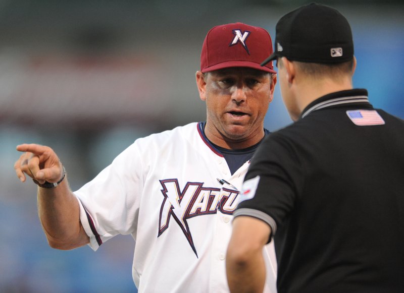 Northwest Arkansas Naturals manager Vance Wilson argues a call with umpire Cody Oakes on July 23 at Arvest Ballpark in Springdale.