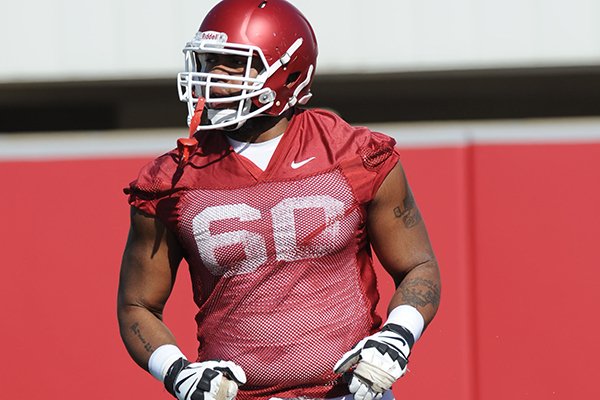 Arkansas offensive lineman Brian Wallace takes part in a drill Tuesday, March 29, 2016, during practice at the university's practice field on campus in Fayetteville.