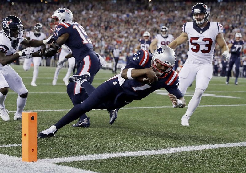New England rookie quarterback Jacoby Brissett (left) dives into the end zone to complete a 27-yard touchdown run during the Patriots’ 27-0 victory Thursday night. Brissett fi nished with 151 total yards of offense to help New England move to 3-0 on the season.