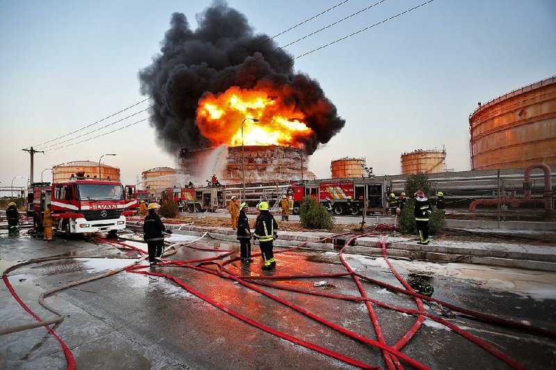 Firefi ghters try to extinguish a blaze on July 4 at the Bou Ali Sina Petrochemical Complex at the Imam Khomeini port in southwestern Iran.