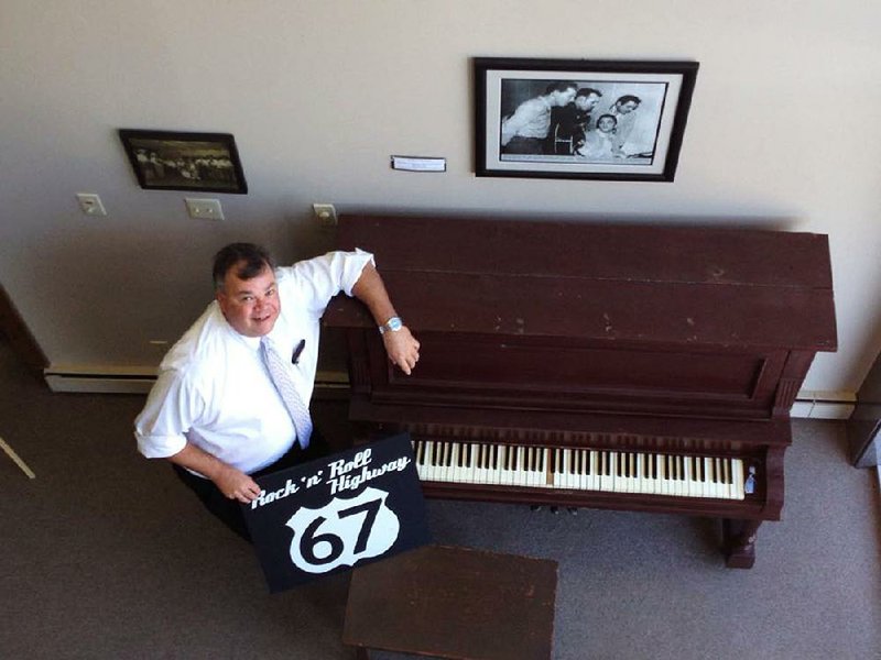 Henry Boyce displays a piano at his Rock ‘n’ Roll Highway 67 Museum that was present during Elvis Presley’s 1955 show at Porky’s Rooftop Club in Newport.