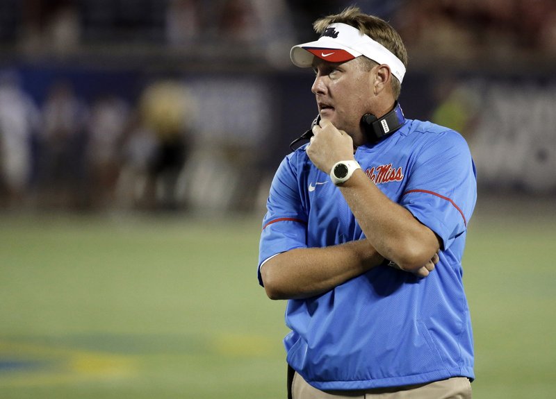 In this Sept. 5, 2016, file photo, Mississippi head coach Hugh Freeze has a moment to himself during a timeout during the first half of an NCAA college football game against Florida State, Monday, Sept. 5, 2016, in Orlando, Fla. 