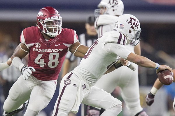 Arkansas defensive end Deatrich Wise (48) rushes Texas A&M quarterback Kyle Allen during a game Saturday, Sept. 26, 2015, in Arlington, Texas. 