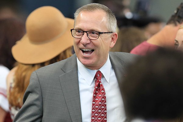 Arkansas athletics director Jeff Long talks with fans prior to a game against Texas A&M on Saturday, Sept. 26, 2015, in Arlington, Texas. 
