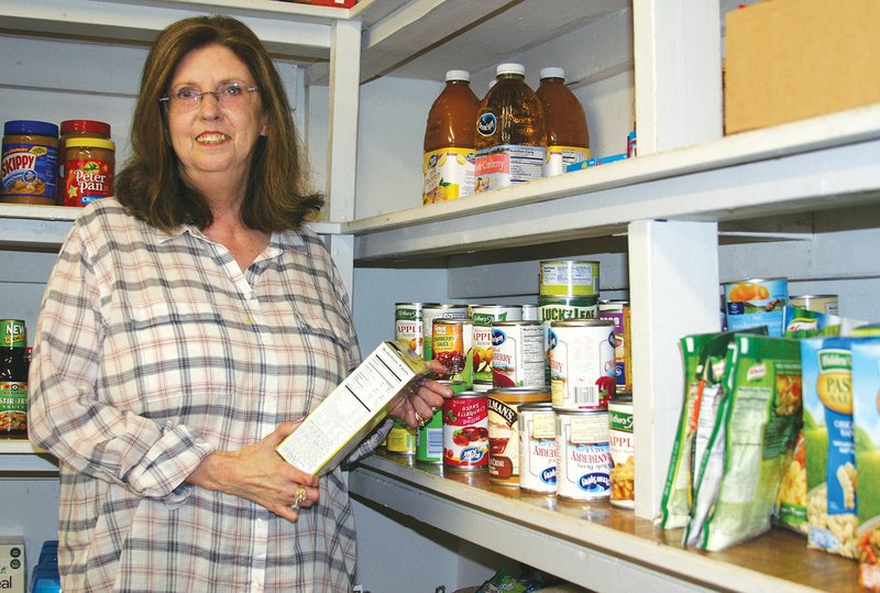 Pam Ray, food coordinator for the Churches Joint Council on Human Needs, helps stock some of the items at the food pantry in Benton. CJCOHN celebrated 40 years of service to Saline County on Sept. 18.