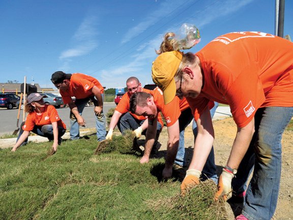 Home Depot volunteers lay sod for the 11th annual Apostles Build of Habitat for Humanity of Saline County. From left are Tamra Rodgers, John George, Jared Castleton, store manger Michael Gatewood and Sheri Street.