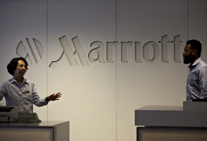 Employees work in the Marriott International Inc. headquarters in Bethesda, Md., in this file photo. Marriott International closed Friday morning on a $13 billion purchase of Starwood Hotels & Resorts Worldwide.
