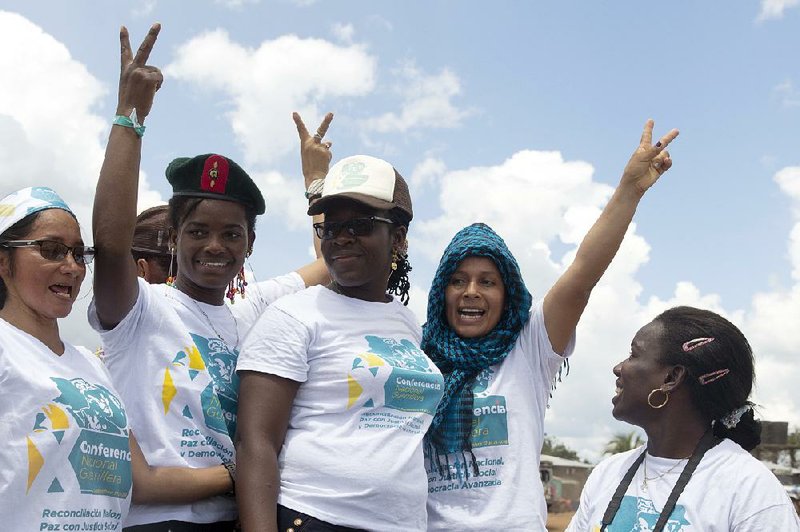 Rebel delegates celebrate Friday after the leadership of the Revolutionary Armed Forces of Colombia ratified the peace deal with the Colombian government in the final statement of their 10th conference in Yari Plains, Colombia.