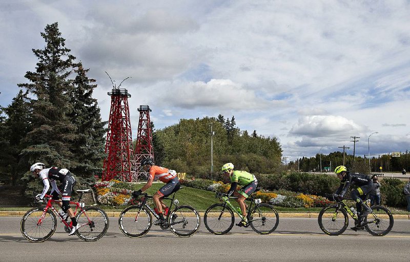 Riders in Stage 3 of the Tour of Alberta pass oil derricks in Drayton Valley in Canada earlier this month. The U.S. imported 3.46 million barrels of oil a day last week from Canada, the U.S. Energy Information Administration reported, the most since the agency began collecting such data in 2010.