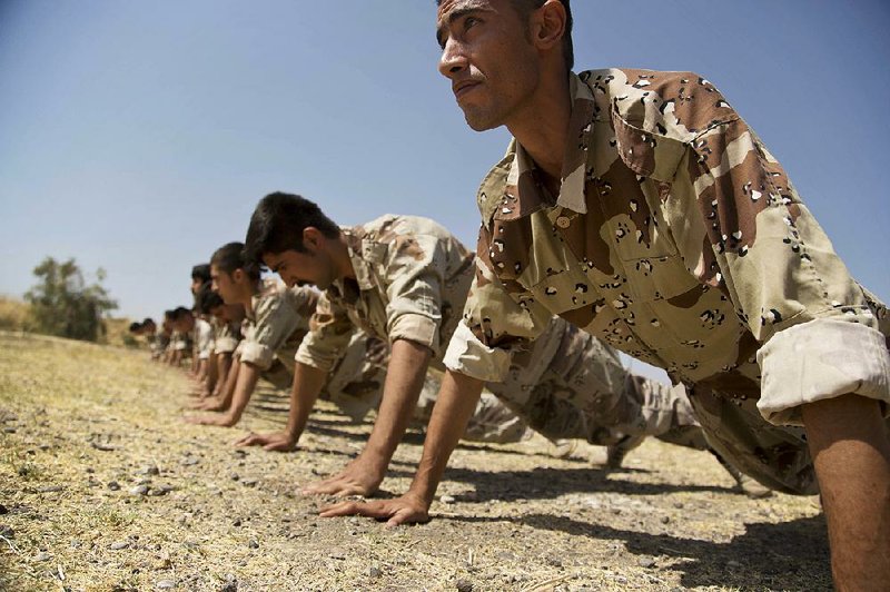 New recruits train Wednesday at a Democratic Party of Iranian Kurdistan base in Koya in northern Iraq.