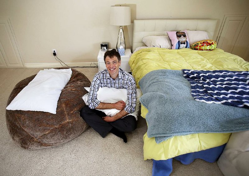 Dan Sanker sits in his favorite personal space Thursday, September 15, 2016, the area that was between the two beds of his children where he would sleep to guarantee all a good night sleep for all at his family's home in Fayetteville.
