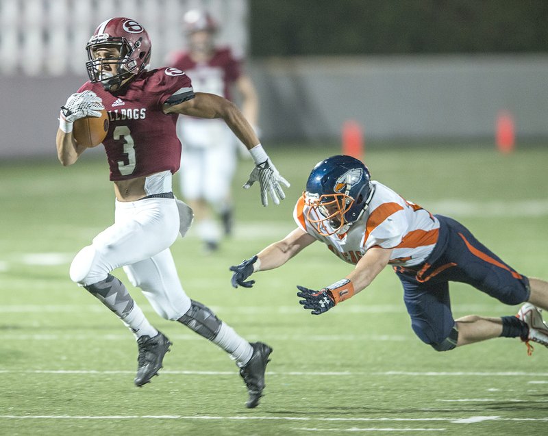 Kyler Williams (3) of Springdale slips away from Cameron Gibson (10) of Rogers Heritage for a long touchdown Friday, Sept. 23, 2016 at Jarrell Williams Bulldog Stadium in Springdale. 