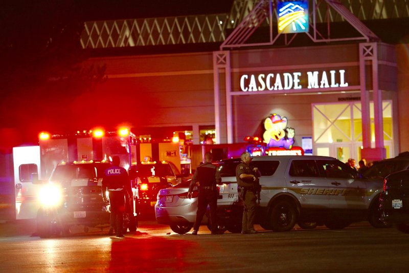 Law enforcement officers work at the crime scene outside of Cascade Mall in Burlington, Wash., where several people were fatally shot on Friday. 