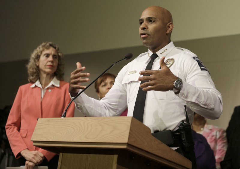 FILE - In this Friday, Sept. 23, 2016 file photo, Charlotte-Mecklenburg Police chief Kerr Putney, right, gestures as Charlotte mayor Jennifer Roberts, left, watches in Charlotte, N.C., during a news conference concerning protests and the investigation into Tuesday's fatal police shooting of Keith Lamont Scott. Putney told reporters Friday that at least one body camera and one dashboard camera recorded footage of the shooting. He said "it's a matter of when" the video will be released. (AP Photo/Chuck Burton, File)
