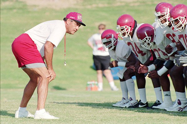 Arkansas Offensive Line coach Mike Bender, left, puts his players through drills during practice on Aug. 15, 1995. (AP Photo/Gary Yandell)