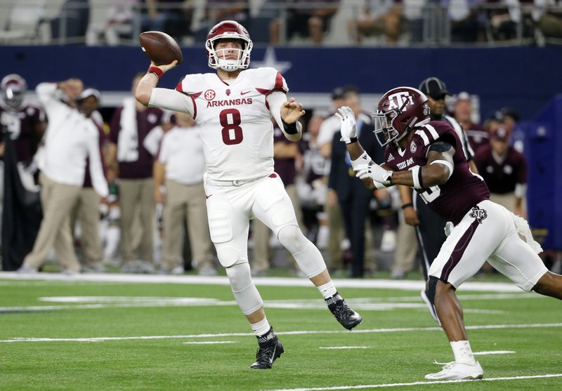 Arkansas quarterback Austin Allen (8) throws the ball under pressure from Texas A&M defensive back Armani Watts (23) in the first half of an NCAA college football game, Saturday, Sept. 24, 2016, in Arlington, Texas. (AP Photo/Tony Gutierrez)
