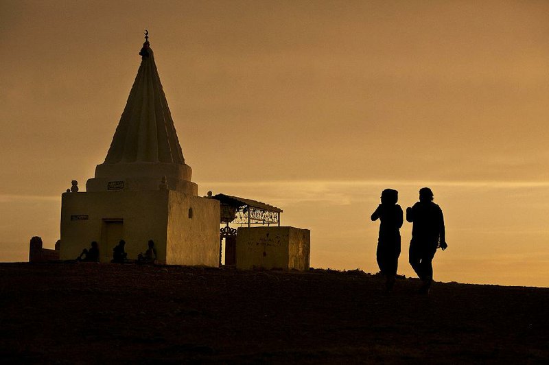 Women visit a Yazidi shrine overlooking a camp for displaced people in Dahuk, Iraq, earlier this year. Lawyers in Europe say they have a legal case against Islamic State militant leaders in the kidnappings of Yazidi women.