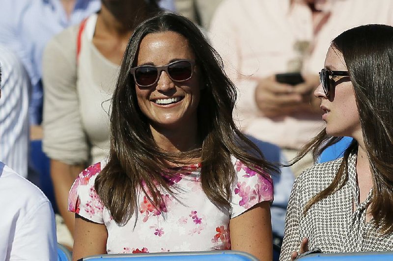 FILE- In this Friday, June 19, 2015 file photo, Pippa Middleton, left, the sister of Kate, the Duchess of Cambridge, watches the quarterfinal tennis match between Canada's Milos Raonic and France's Gilles Simon on the fifth day of the Queen's Championships in London. 