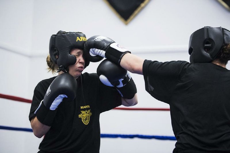 Women cadets trade punches during boxing class at the U.S. Military Academy. “At first I was kind of upset, but now I’m getting into it,” one female cadet said