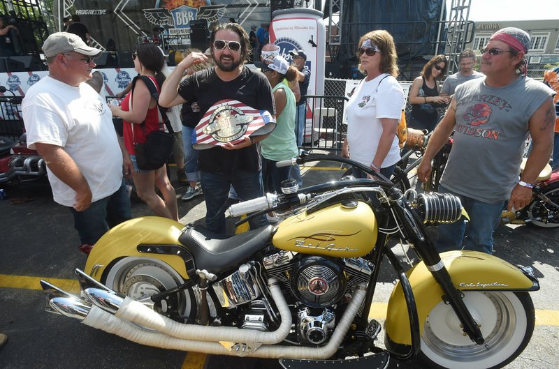 Scotty Robertson from Steele, Mo., reacts Saturday after winning the Best of Show at the Battle of the Bikes competition during the annual Bikes, Blues & BBQ motorcycle rally in Fayetteville. Robertson, also known as “Memphis” by his friends, has won best of show four times with his unique custom builds.