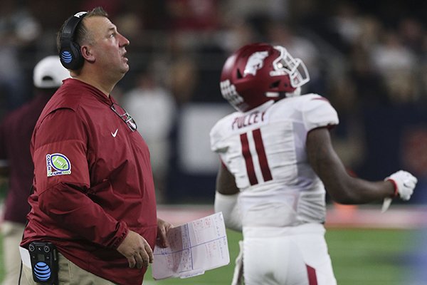 Arkansas coach Bret Bielema watches a replay after safety De'Andre Coley was flagged for targeting during a game against Texas A&M on Saturday, Sept. 24, 2016, in Arlington, Texas. 