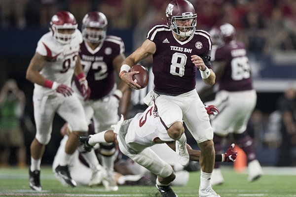 Texas A&M quarterback Trevor Knight (8) breaks loose to score a long rushing touchdown late in the second quarter against Arkansas in an NCAA college football game Saturday, Sept. 24, 2016, in Arlington, Texas. (Timothy Hurst/Bryan-College Station Eagle via AP)

