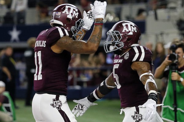 Texas A&M wide receiver Josh Reynolds (11) and running back Trayveon Williams (5) celebrate a touchdown run by Williams during the second half of an NCAA college football game against Arkansas on Saturday, Sept. 24, 2016, in Arlington, Texas. (AP Photo/Tony Gutierrez)