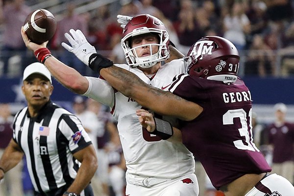 Arkansas quarterback Austin Allen (8) throws an incomplete pass as he's hit by Texas A&M linebacker Claude George (31) during the first half of an NCAA college football game, Saturday, Sept. 24, 2016, in Arlington, Texas. (AP Photo/Tony Gutierrez)

