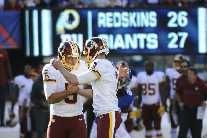 Washington Redskins kicker Dustin Hopkins (right) celebrates with teammate Tress Way after kicking a field goal during the second half of Sunday’s game against the New York Giants in East Rutherford, N.J. The Redskins won 29-27.