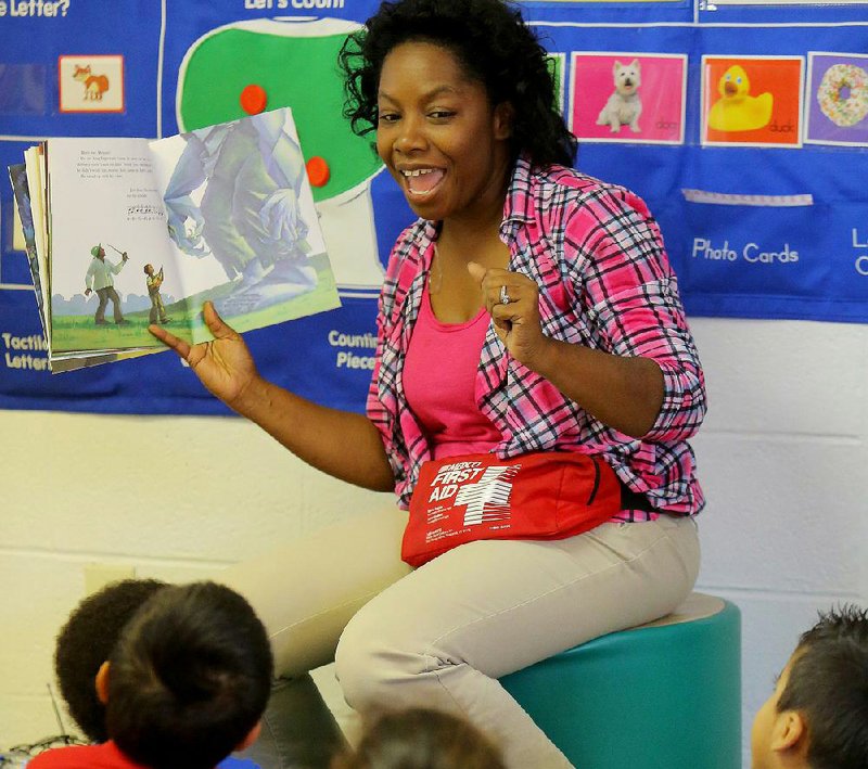 Teacher Cassandra Roy combines positive facial expressions and story-related questions to engage her 3-, 4-, and 5-year-old students during reading time this month at the UAMS Kennedy Head Start in Little Rock.