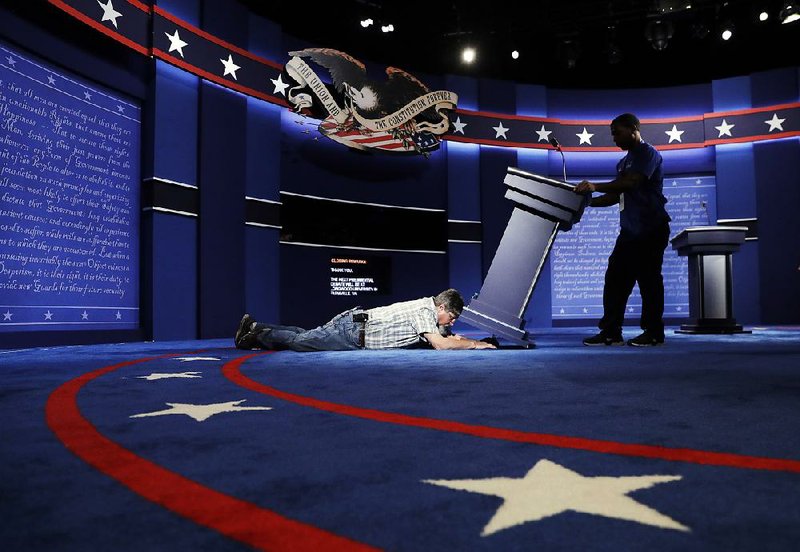 Technicians set up the stage Sunday for tonight’s presidential debate between Democratic presidential candidate Hillary Clinton and Republican presidential candidate Donald Trump at Hofstra University in Hempstead, N.Y.