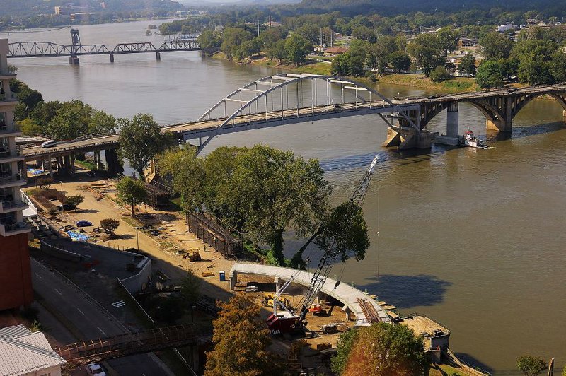 Ramp construction (foreground) goes on near the Broadway Bridge over the Arkansas River on Thursday. The bridge will close this week for a scheduled six-month construction of a new bridge.
