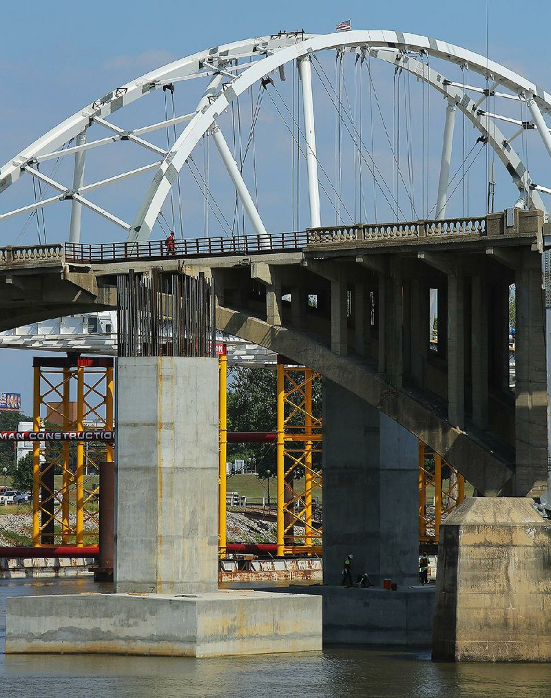 The current Broadway Bridge, with its white-arched replacement under construction in the background, will be shut down Wednesday and is scheduled to be closed for six months.