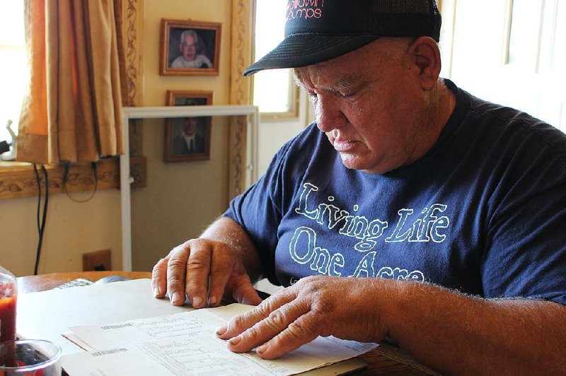 Jan Brown looks over a royalty statement earlier this month at his home in Wyalusing, Pa. Brown and other landowners with natural gas wells contend that gas companies are ripping them off by taking improper deductions from their royalty checks. The drilling industry says the deductions are proper.