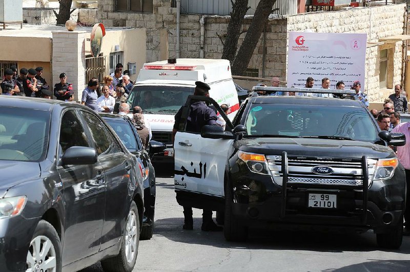 An ambulance transports the body of Jordanian writer Nahed Hattar to a hospital after he was shot in Amman, Jordan, on Sunday.