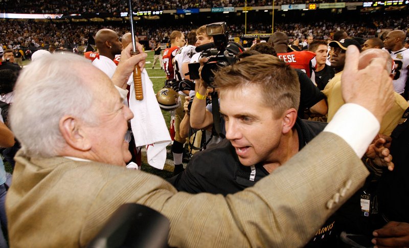 File-This Sept. 25, 2006, file photo shows New Orleans Saints owner Tom Benson, left, hugging coach Sean Payton after their football game with Atlanta Falcons at the newly re-opened Louisiana Superdome in New Orleans. Payton sees Monday night&#x2019;s matchup with rival Atlanta as a separate event from the 10th anniversary of the Superdome&#x2019;s reopening after Hurricane Katrina. (AP Photo/Alex Brandon, File)