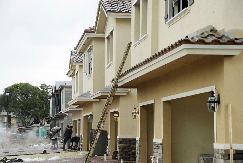 Work continues Thursday on townhouses at Chelsea Place in Tamarac, Fla. Sales of new houses fell 7.6 percent in August to a 609,000 annualized pace, the Commerce Department reported.