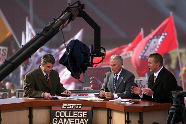 ESPN announcers Chris Fowler (left), Lee Corso (center) and Kirk Herbstreit sit on the College GameDay set prior to a game between Arkansas and Tennessee on Saturday, Nov. 11, 2006, in Fayetteville. 