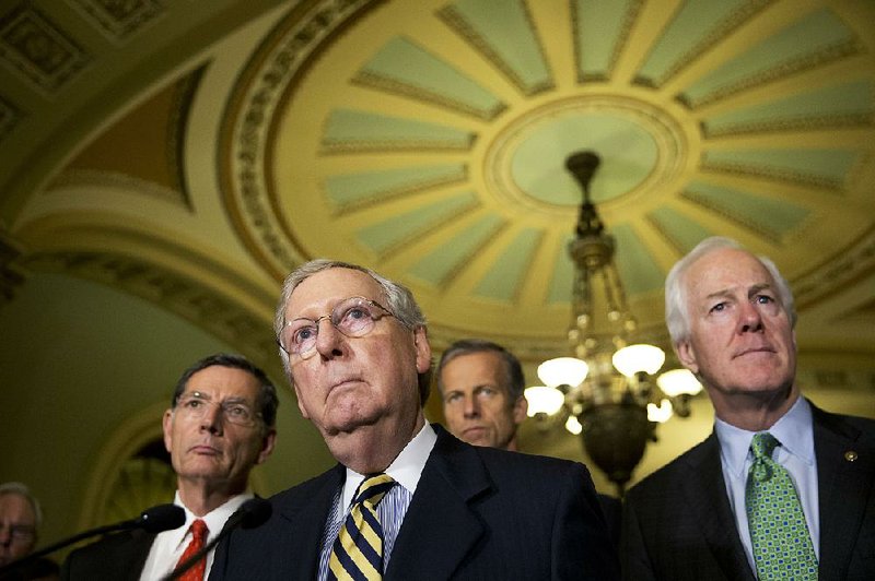 Senate Majority Leader Mitch McConnell (center), shown June 21 with Sen. John Barrasso (left), R-Wyo., and Senate Majority Whip John Cornyn of Texas, on Tuesday suggested Senate Democrats “have embraced dysfunction” and are intent on “bringing our country to the brink” in blocking a stopgap spending bill because it omits funding for the lead-contaminated water crisis in Flint, Mich.