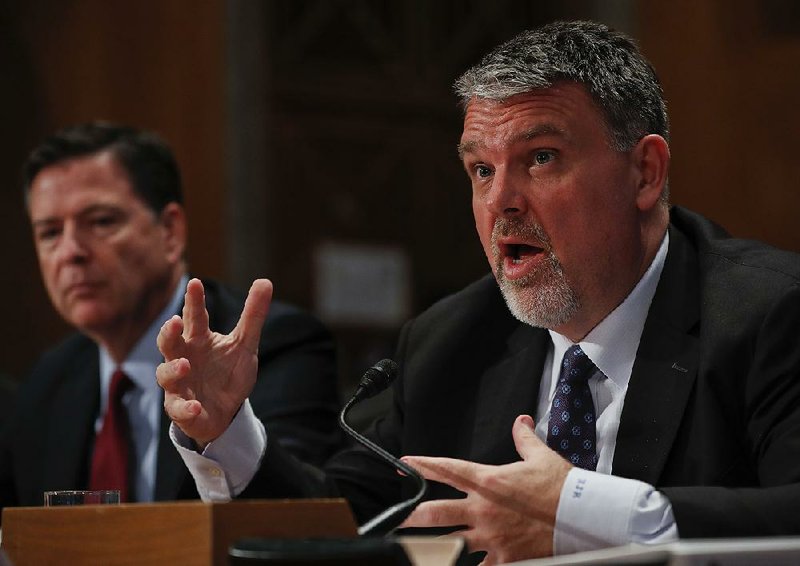Nicholas Rasmussen (right), head of national counterterrorism center in the Office of the Director of National Intelligence, accompanied by FBI Director James Comey, testifi es Tuesday on Capitol Hill in Washington.