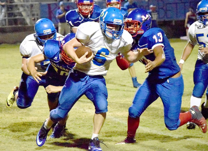 Photo by Mike Eckels Decatur&#8217;s Troy Kell (6) fights off several Dragon tackle attempts during the Sept. 23 Decatur-Mountainburg conference game in Mountainburg. The Dragons took the victory, 50 to 6.