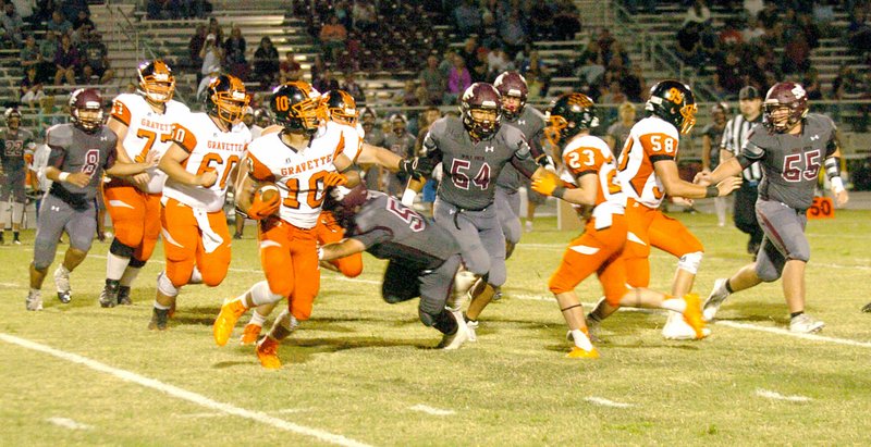 Photo by Mark Humphrey Austin O&#8217;Brien carried the ball for Gravette in this 65-yard run against Lincoln on Friday. O&#8217;Brien ran 12 times for 136 yards and caught six passes for 109 yards and a touchdown in the game at Lincoln.