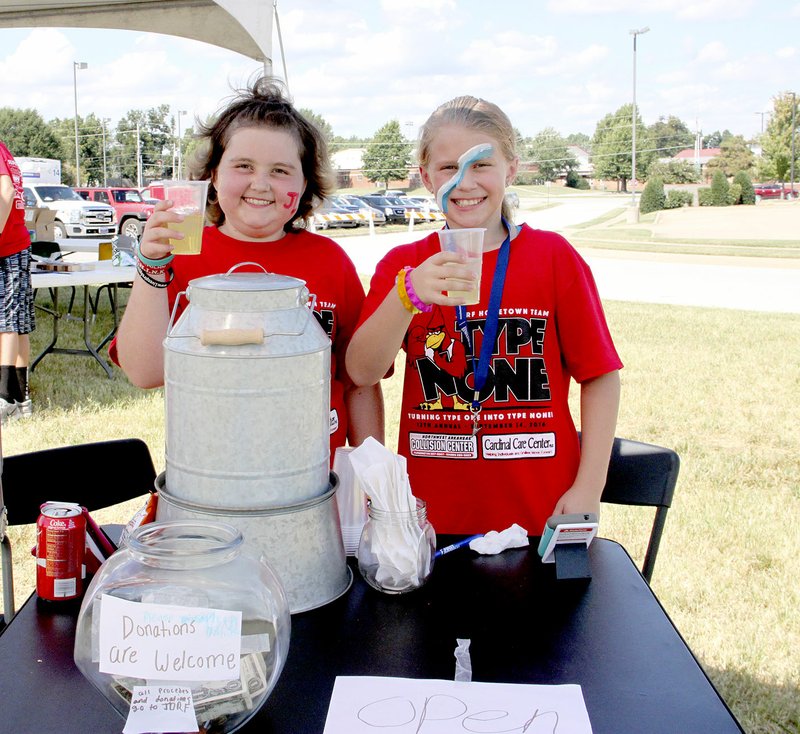 LYNN KUTTER ENTERPRISE-LEADER Addison Alford, left, and her friend Emily Henson set up a lemonade stand with donations going to the Juvenile Diabetes Research Foundation. Addison deals with her own medical problems but Saturday, she was helping her classmates with Type 1 diabetes.